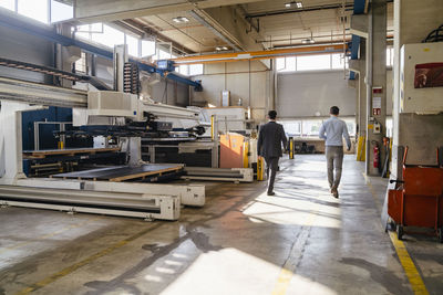 Business people walking at factory