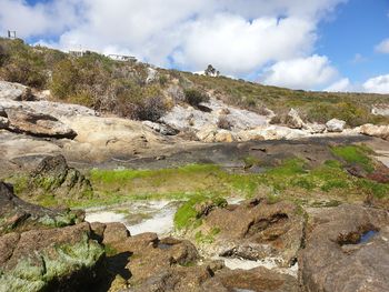 Scenic view of rocks on land against sky