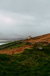 Scenic view of land and sea against sky