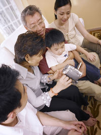 Family looking into video camera while sitting at home