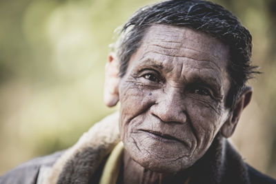 Close-up portrait of smiling man outdoors