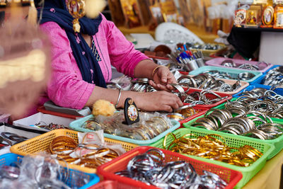 Midsection of woman preparing food for sale