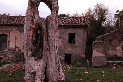 Old ruins in cemetery against sky