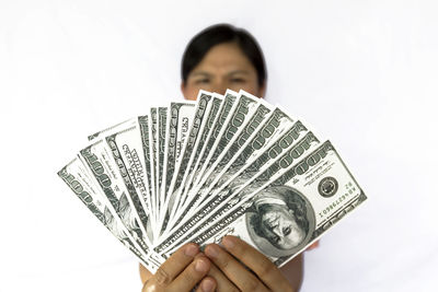 Midsection of man holding camera against white background