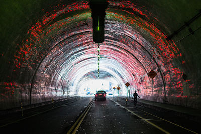 Cars in illuminated tunnel