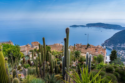 High angle view of townscape by sea against sky