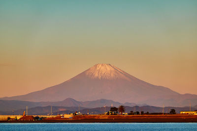 Scenic view of snowcapped mountains against sky during sunrise