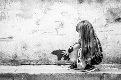 Young woman sitting on floor