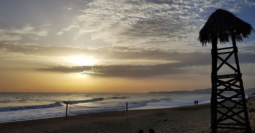 Scenic view of beach against sky during sunset