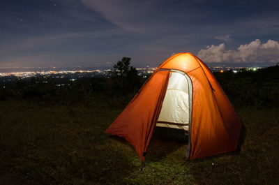 Tent on field against sky during sunset