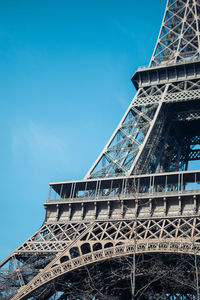 Low angle view of eiffel tower against clear blue sky