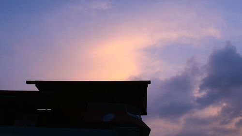 Low angle view of silhouette building against sky