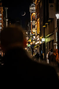 People walking on street at night