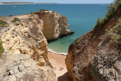High angle view of rocks on sea shore
