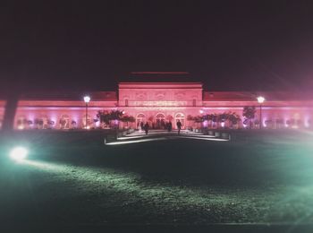 People in front of illuminated building at night