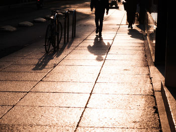 Low section of man walking on sidewalk