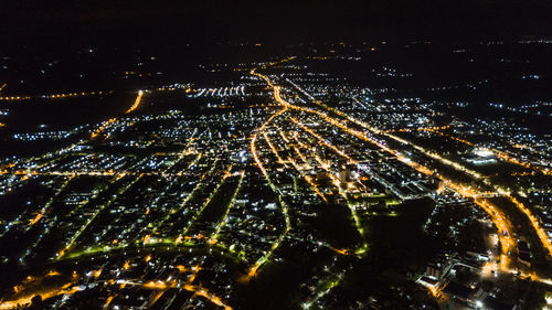 High angle view of illuminated buildings in city at night