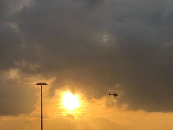 Low angle view of silhouette birds flying against sky during sunset