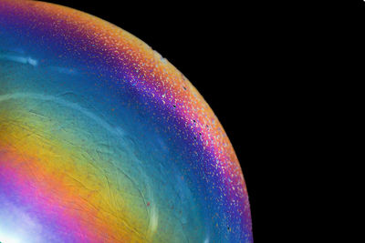 Close-up of rainbow over black background
