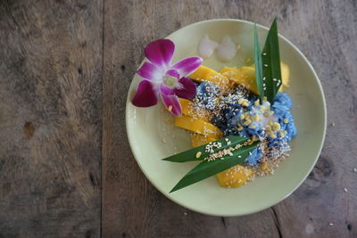 Close-up of multi colored flower in plate on table