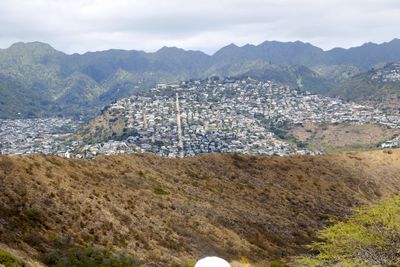 High angle view of city and mountains against sky