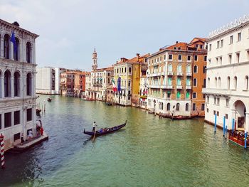 A traditional italian gondola drives people across the grand canal in venice