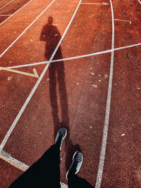 Low section of person standing on track 