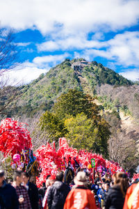 Woman standing on mountain against sky