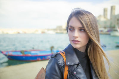 Portrait of beautiful young woman standing outdoors