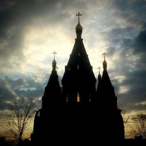 Low angle view of church against cloudy sky