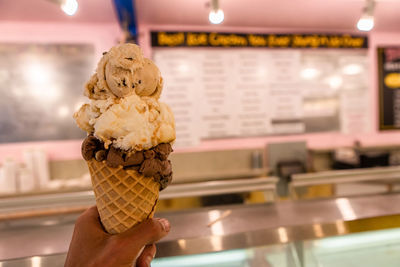 Close-up of hand holding ice cream cone