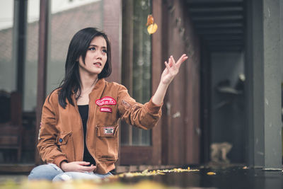 Young woman with arms raised