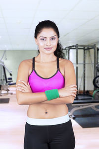 Portrait of confident mid adult woman standing in gym