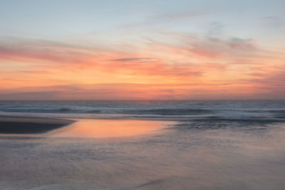 Scenic view of beach against sky during sunset