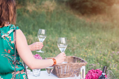 Close-up of young woman in basket on field