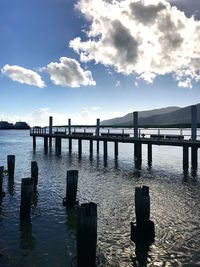 Pier over river against sky