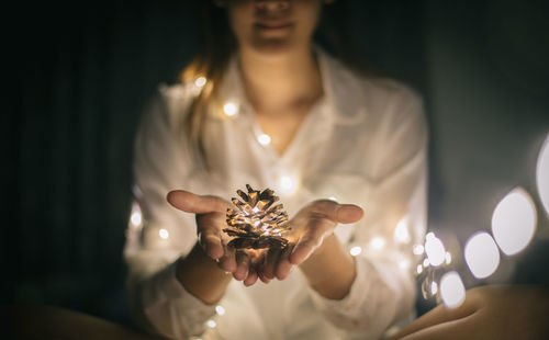 Close-up of woman holding white flowers