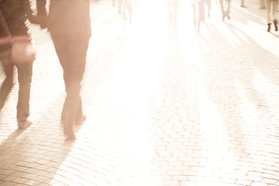 Low section of woman walking on floor