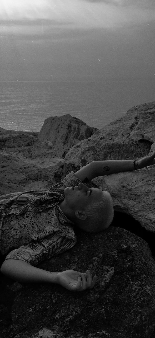 HIGH ANGLE VIEW OF GIRL LYING ON SHORE