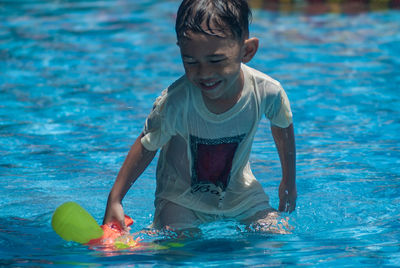 Portrait of young man at swimming pool with fully happiness 