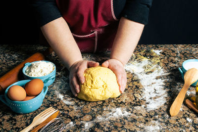 Midsection of man preparing food on table