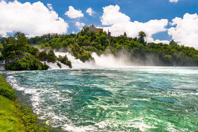 Beautiful, turquoise rhine river flowing from a waterfall in northern switzerland.