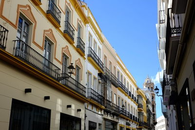 Low angle view of buildings against blue sky