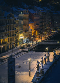 High angle view of illuminated buildings in city at night