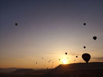 Hot air balloons flying in sky during sunset