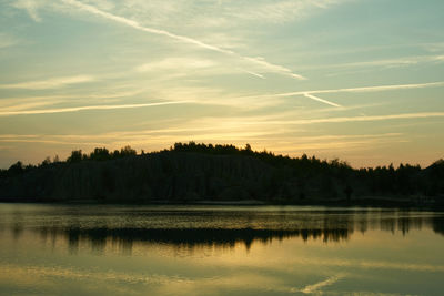 Scenic view of lake against sky at sunset