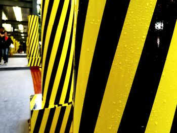 Close-up of yellow umbrella on road in city