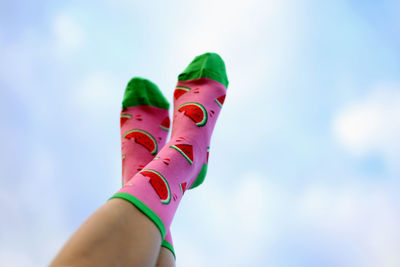 Low section of woman wearing socks against sky