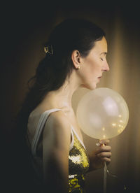 Woman behind an illuminated balloon iv