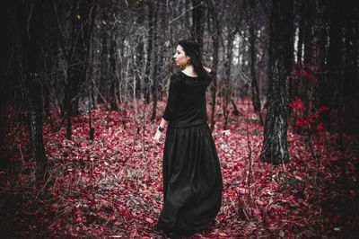 Woman standing in forest